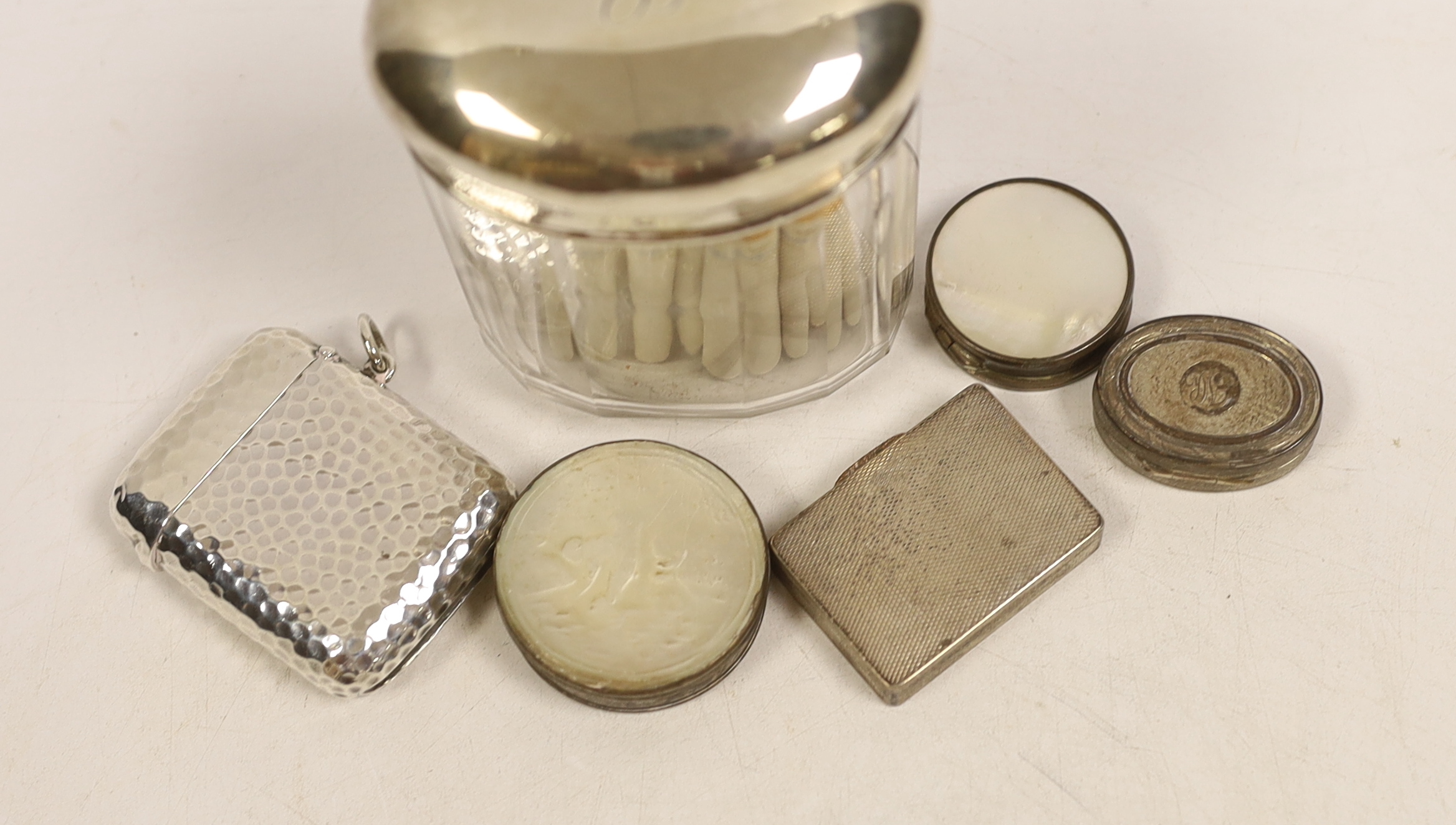 A large hammered silver vesta case by Sampson Mordan & Co., London 1900, 56mm, a small engine turned silver oblong pill box (London 1933) and four other items.